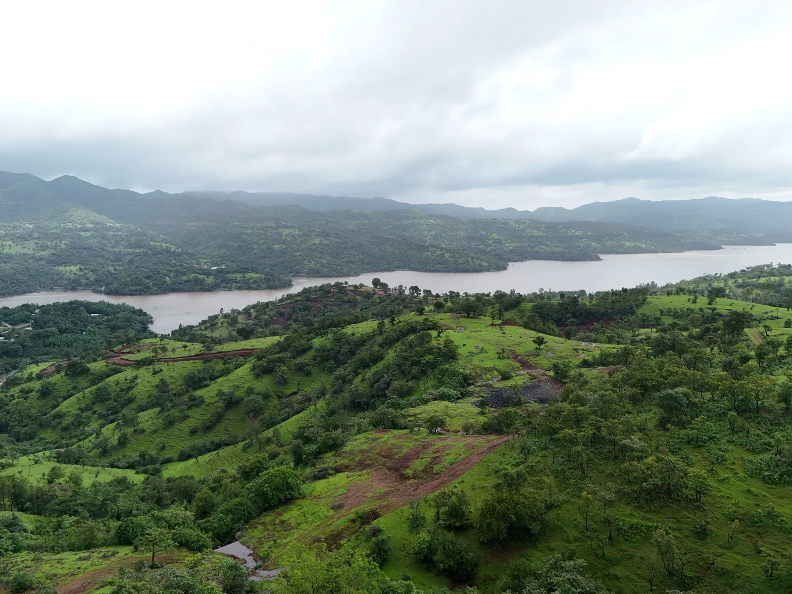 A river bend held between green hills, seen from above.